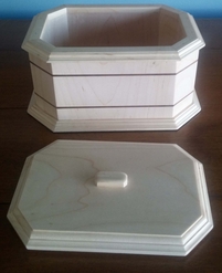 Maple jewelry box has ebony inlays with lid removed. Bottom inside is black velvet covered.